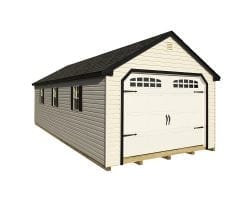 Beige signature cape code garage with cream colored doors and a black roof.