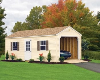 Beige colored vinyl garage with green shutters and a brown roof.