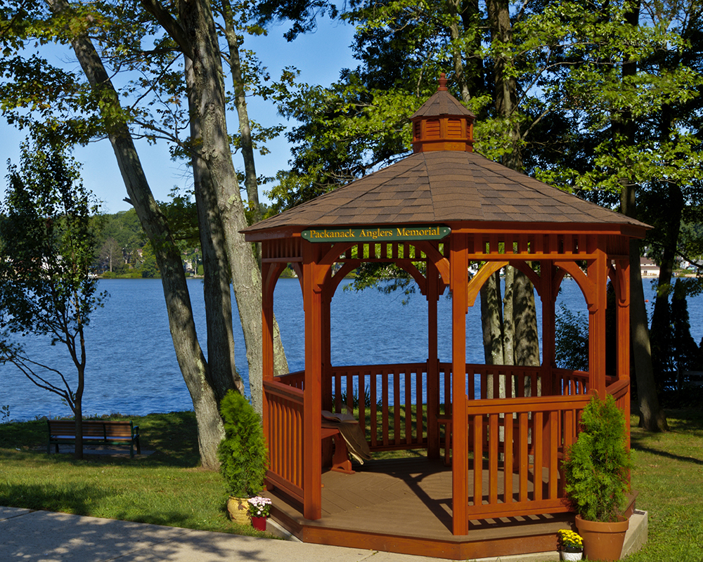 Octagonal dutch style wood gazebo beside a river.