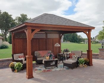 Traditional canyon brown wood pavilion with a privacy wall on a backyard patio.