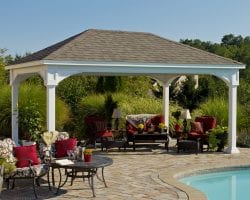 Traditional white vinyl pavilion on a brick patio by the pool.