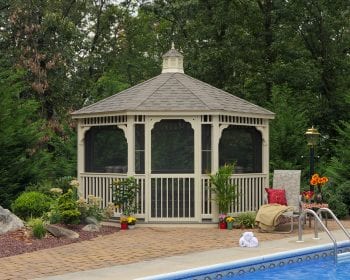 Ivory octagonal gazebo with screens on a patio by the pool.