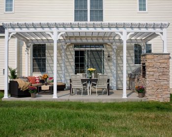 Traditional white vinyl pergola with a lattice roof on a backyard patio.