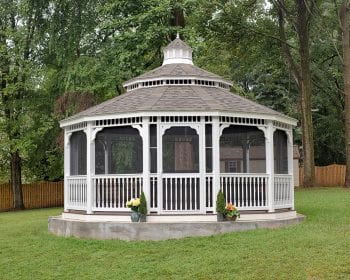 White dodecagonal country style gazebo with screens and a pagoda roof.