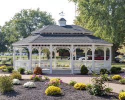 Oval colonial style white vinyl gazebo with a pagoda roof and no floors.