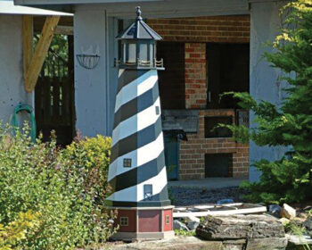 6' Cape Hatteras Hybrid Lighthouse by a fish pond.