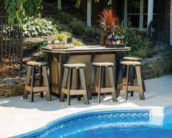 Brown and black SummerSide bar and stools on a patio by the pool.