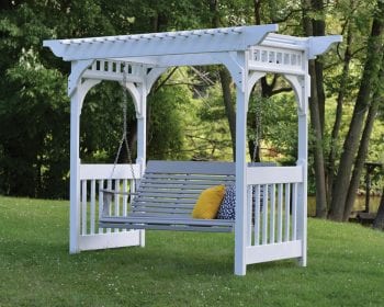 White arbor with swing in a backyard.