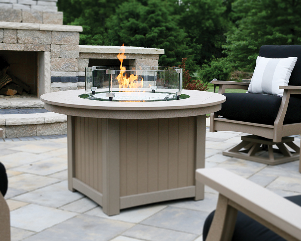 Tan Donoma fire pit on a patio.