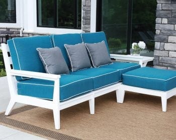 White Mayhew sofa and ottoman with blue cushions.